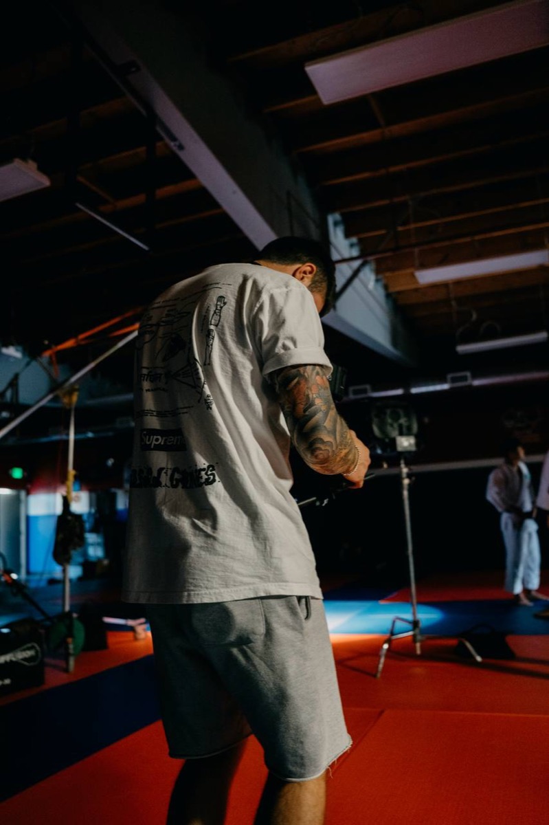 Crew filming on a gym mat with a boom mic