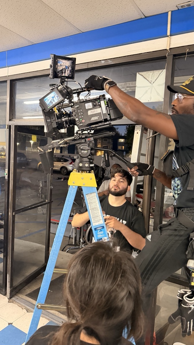 Night shoot at a storefront with the camera rigged on a ladder