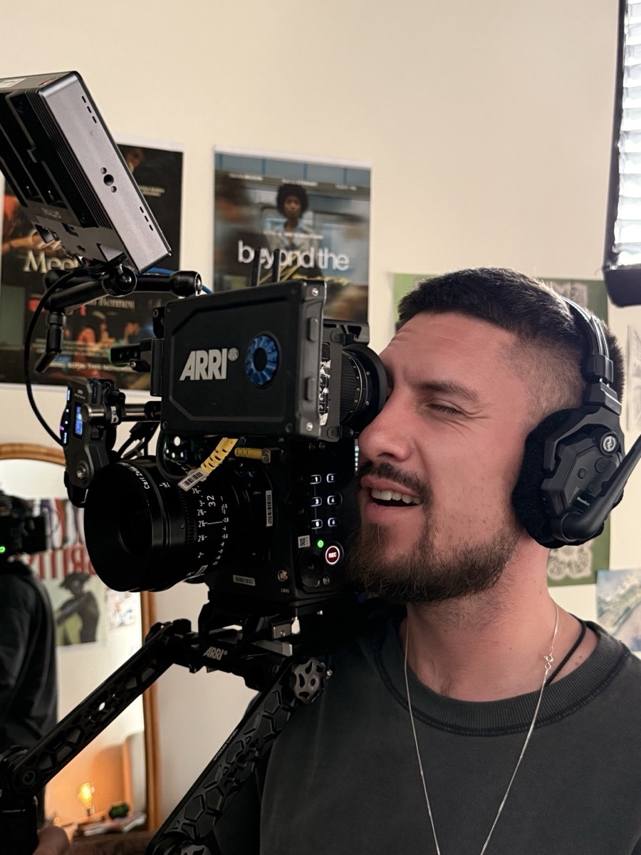 Close-up of a camera operator looking through the viewfinder
